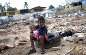 Six-year-old Charles Kerby hold his 11-month-old sister Mikerlina Dragon inside the Ste Therese camp, set up for people displaced by the 2010 earthquake, in Petion-Ville, Haiti, in June 2012. Kerby had to drop out of school after the 2010 earthquake to help his working mother care for his two brothers and sisters. (Dieu Nalio Chery/AP)  